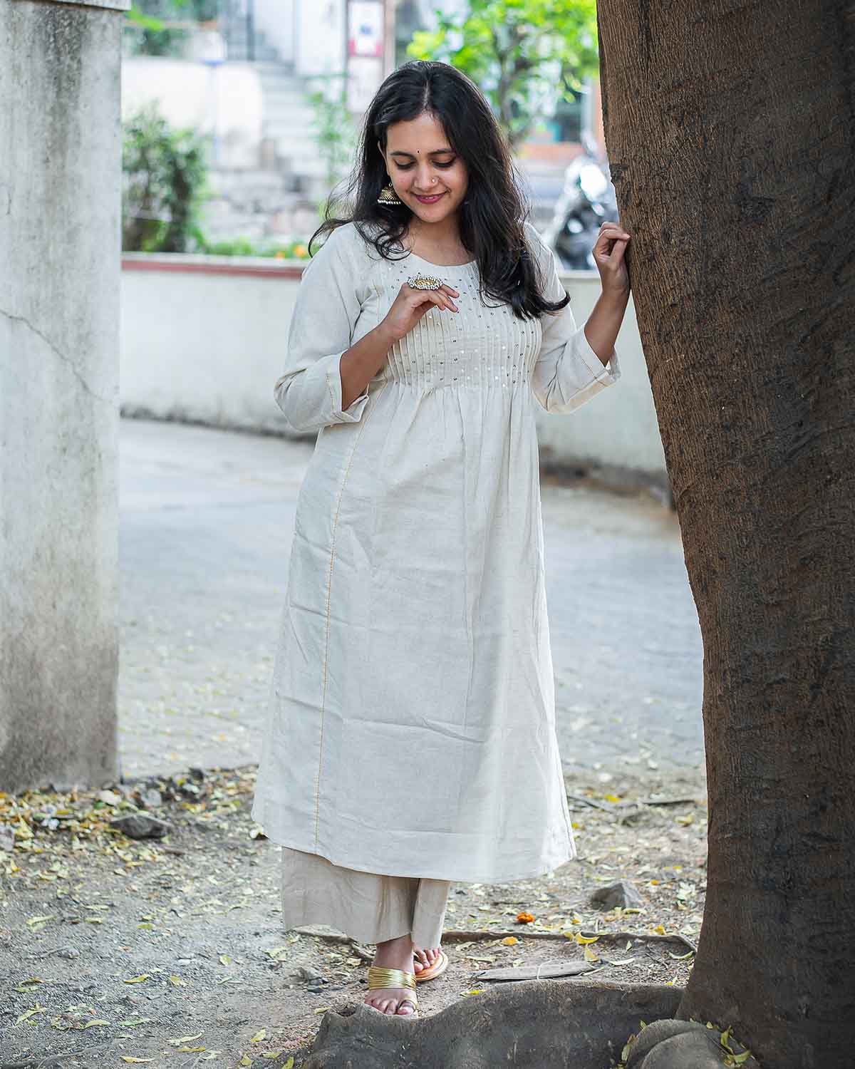 Cream Sequin work kurta with side cut. Pattern with pleats