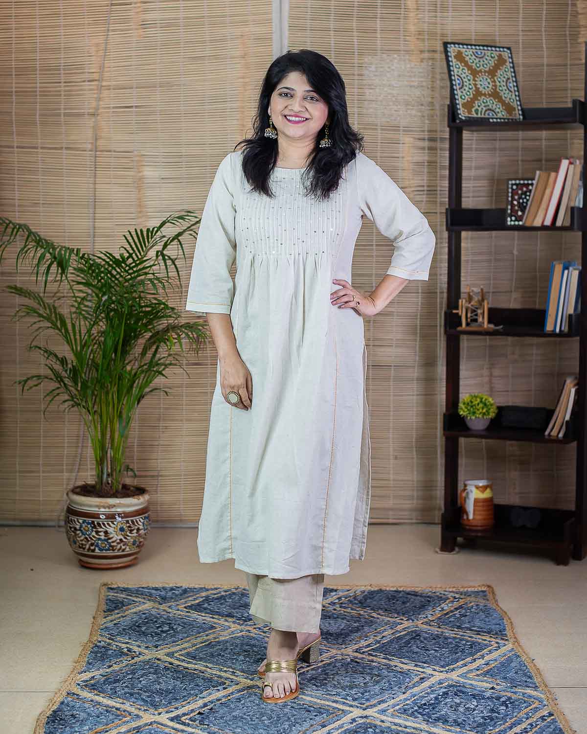 Cream Sequin work kurta with side cut. Pattern with pleats